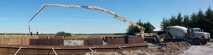 A Cousineau Concrete Pumping truck working on a job site.